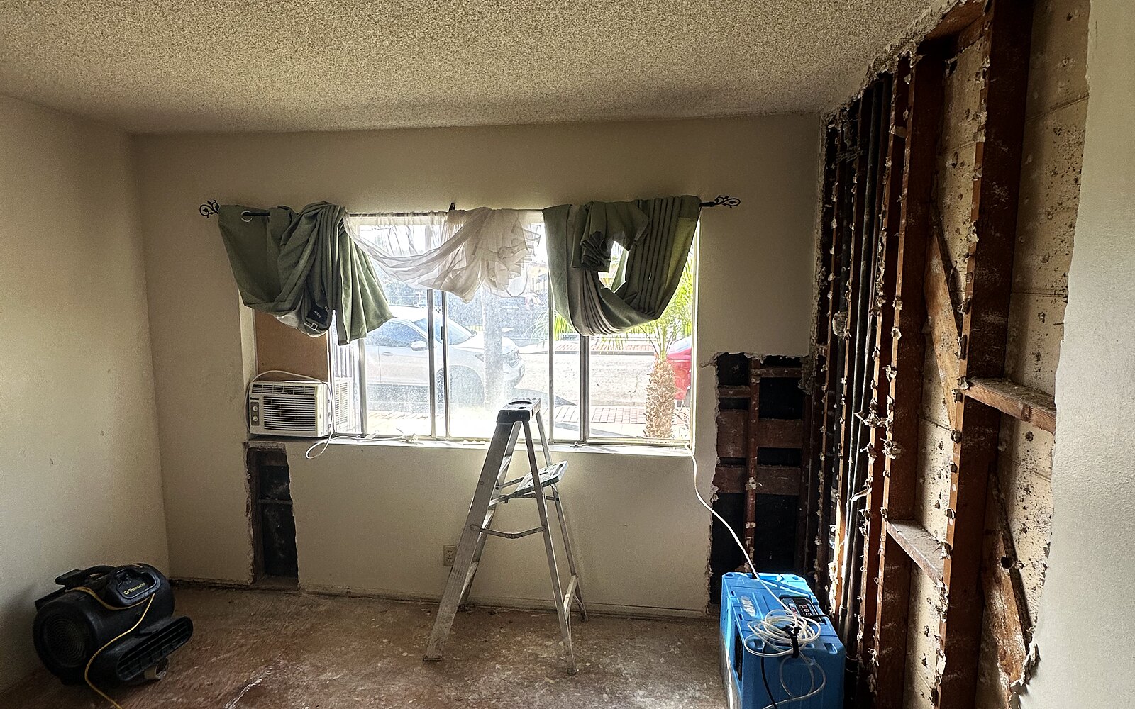 Before: water-damaged room mid-restoration